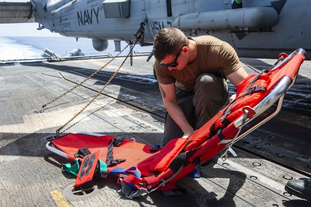 210704-N-RG587-1012 MEDITERRANEAN SEA (July 4, 2021) Naval Aircrewman (Tactical Helicopter) 3rd Class Bryan Johnson, from Murietta, California, assembles a search-and-rescue litter aboard guided-missile cruiser USS Vella Gulf (CG 72), during operations in the Mediterranean Sea, July 4. Vella Gulf is operating with the Eisenhower Carrier Strike Group on a routine deployment in the U.S. Sixth Fleet area of operations in support of U.S. national interests and security in Europe and Africa. (U.S. Navy photo by Mass Communication Specialist 2nd Class Dean M. Cates)