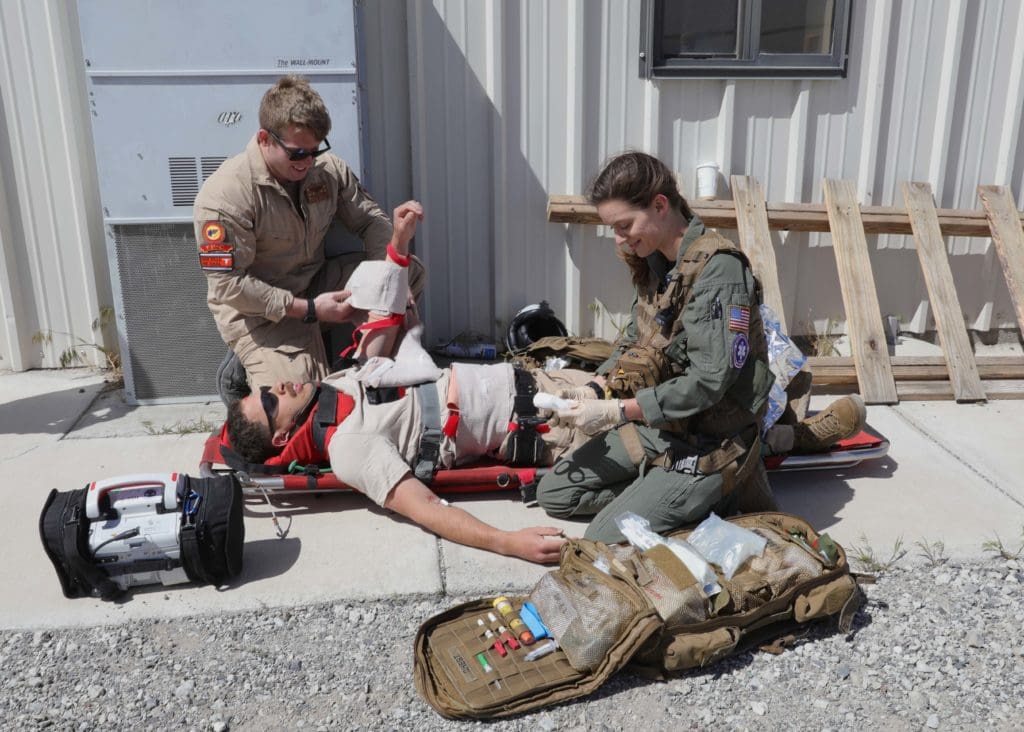 Hospital Corpsman 3rd Class Lauren Thomas, the Search and Rescue Medical Technician (SMT) in training attached to Helicopter Sea Combat Squadron (HSC) 5, right, performs a single patient trauma scenario administered by Hospital Corpsman 2nd Class Blake Campbell during HSC-5's training at Naval Air Station Fallon. Carrier Air Wing (CVW) 7 is the offensive air and strike component of Carrier Strike Group (CSG) 10 and the George H.W. Bush CSG. The squadrons of CVW-7 are Strike Fighter Squadron (VFA) 143, VFA-103, VFA-86, VFA-136, Electronic Attack Squadron (VAQ) 140, Carrier Airborne Early Warning Squadron (VAW) 121, HSC-5, and Helicopter Maritime Strike Squadron (HSM) 46. (U.S. Navy photo by Mass Communication Specialist 3rd Class Novalee Manzella.)