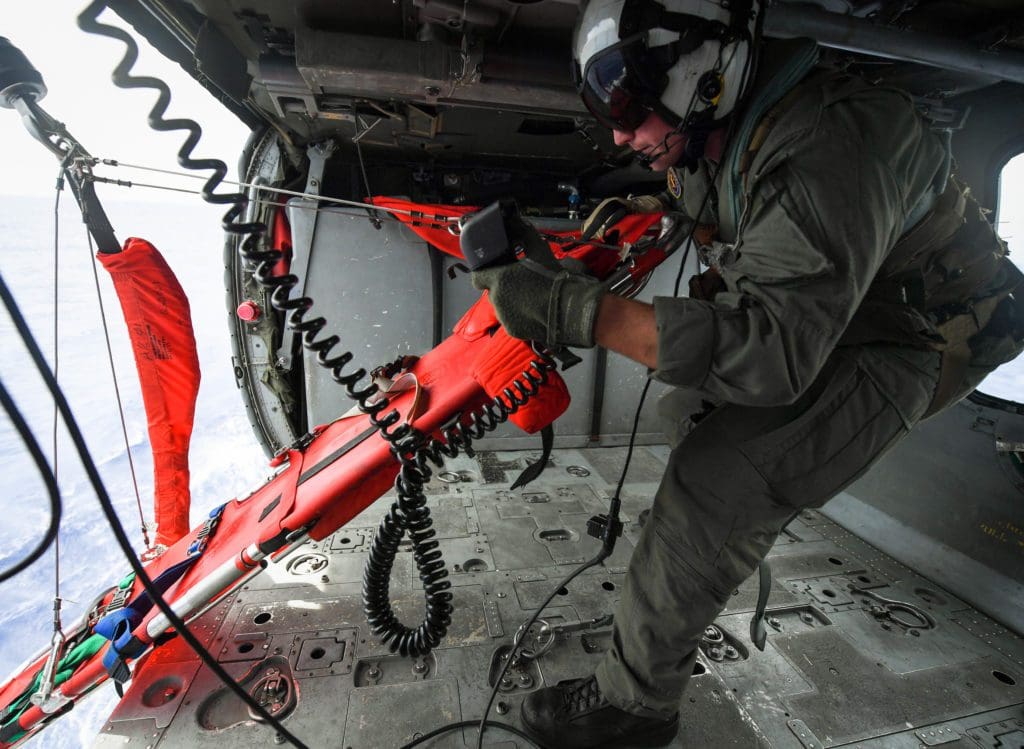Naval Air Crewman (Helicopter) 2nd Class Jacob Ward, assigned to the “Island Knights” of Helicopter Sea Combat Squadron (HSC) 25, hoists a litter onboard an MH-60S Sea Hawk helicopter during a search and rescue exercise with a Mark VI patrol boat assigned to Coastal Riverine Group 1, Det. Guam off the coast of Guam, Feb. 23, 2018. HSC-25 maintains a 24-hour search and rescue and medical evacuation alert posture, directly supporting the U.S. Coast Guard, Sector Guam and Joint Region Marianas. (U.S. Navy Combat Camera photo by Mass Communication Specialist 1st Class Stacy D. Laseter)